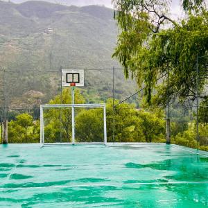 um campo de basquetebol vazio com um cesto de basquetebol em Quinta Estefanía, Paute-Uzhupud em Cuenca