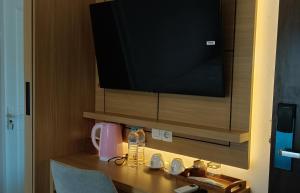 Habitación con TV y mesa con fregadero. en D'Ninety Six Inn Hotel Gunungkidul, en Siyonokulon
