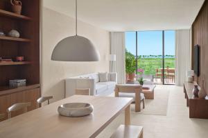 a living room with a white couch and a table at The Riviera Maya EDITION at Kanai in Playa del Carmen