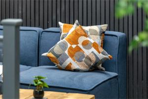 a blue chair with two pillows on it at Modern & Funky 3-BR Duplex with Games Room & Sauna in London