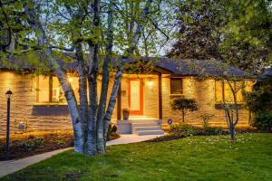 a house with a tree in the front yard at Luxurious & Modern 4BR House w/ 3 Car Parking in Burlington
