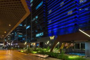 a view of a building with aww sign at night at W Bogota in Bogotá