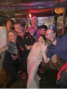 a group of people posing for a picture on a dance floor at Nalani Homestay & Hostel Hoi An in Hoi An