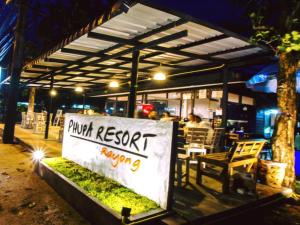a sign in front of a restaurant at night at PHUPA BEACH Resort in Ban Ang