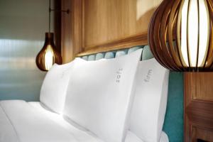 a bed with white pillows on top of it at Holiday Inn Resort Bali Canggu by IHG in Canggu