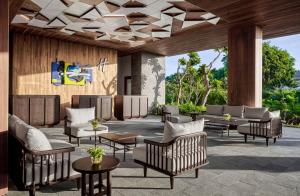 a lobby at the resort with couches and tables at Holiday Inn Resort Bali Canggu by IHG in Canggu