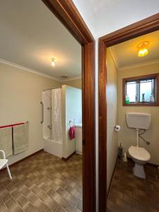 a bathroom with a toilet and a shower at Grassvale Farms Retreat - Lodge in Lindenow
