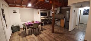 eine Küche und ein Esszimmer mit einem Tisch und Stühlen in der Unterkunft La Cabañita in El Calafate