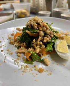 um prato branco com uma salada com nozes em Channel Bass Inn and Restaurant em Chincoteague
