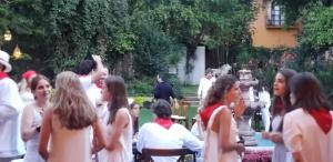 a group of people standing around in a garden at Tres Fuentes Hotel Boutique in San Miguel de Allende