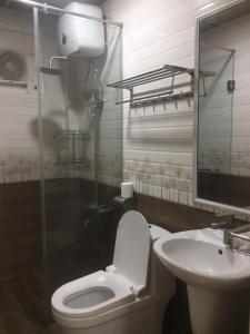 a bathroom with a toilet and a sink at Scent Village Hotel in Da Lat