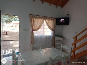 a room with a bed and a television on a wall at Casa en Nueva Atlantis in Mar de Ajó