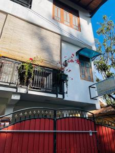 a building with a red door and a balcony at Royal Resort in Weligama