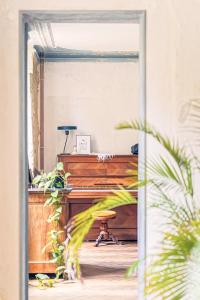 an entrance to a room with a piano at La Nuit & Le Jour in Vertheuil-en-Médoc