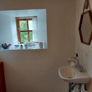 a bathroom with a sink and a window at Kitts Cottage Rural, Woodburner, King Size Bed in Redruth