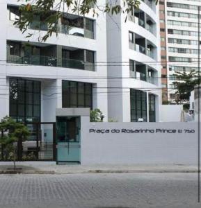 a white building with a sign on the side of it at FLATS ROSARINHO PRINCE SPRING in Recife