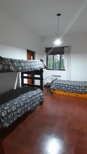 a room with two beds and a window at Hostel Amarillo in San Ignacio