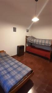a bedroom with two beds and a television in it at Hostel Amarillo in San Ignacio