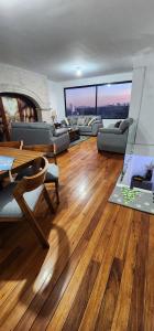 a living room with a wooden floor and a fireplace at Casa lindavista in Guadalajara