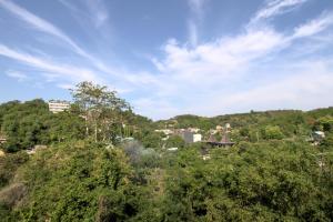 a town on top of a hill with trees at Hotel Bonne Nuit in Labuan Bajo