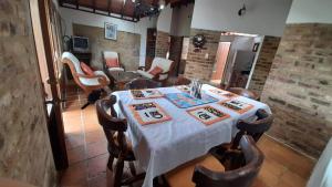 a dining room with a table and chairs at Finca el Fical in Coper