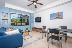 a living room with a blue couch and a table at Beautiful newly refurbished 2 bedroom 2 Bathroom 2nd floor condo in Tamarindo