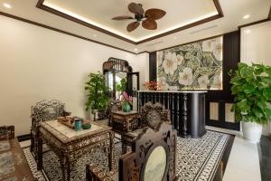 a living room with chairs and a ceiling fan at Stella Marina Boutique Hotel in Phu Quoc