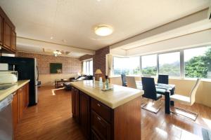 a kitchen and living room with a couch and a table at Green Garden Hills 3F-2 in Okinawa City