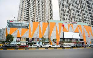 a parking lot with cars parked in front of a building at Dcapitale - Feria Homes in Hanoi