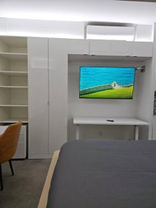 a bedroom with a bed and a tv on a wall at Tremont Smart 10 - A KCM Property in Cleveland