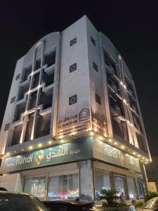 a tall white building with lights on top of it at فندق ايليت الشرق in Jeddah