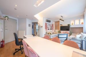 a room with a table and chairs and a living room at The Luxury Loft by Cloudkeys in Athens