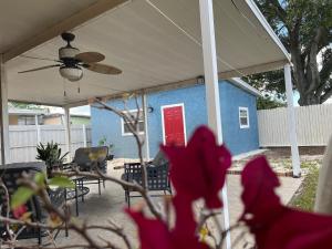 a blue house with a red door on a patio at Loft Close to Downtown, Raymond James Stadium, Airport and Many More Places in Tampa