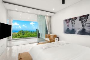 a bedroom with a bed and a large window at Golden Lotus Villas in Amphoe Koh Samui +111 photos