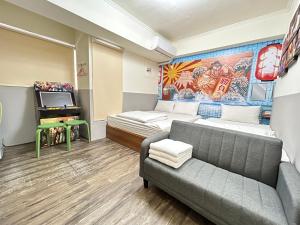 a room with a couch and a bed and a tv at 逢甲 Toy RooM in Taichung