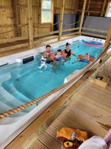 a group of people in a swimming pool at Lovely Glamping Dream Pod in St Austell Cornwall in St Austell