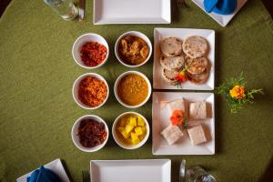 a group of bowls of food on a table at Ferncliff Bungalow in Nuwara Eliya