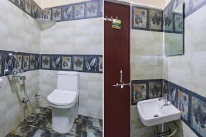 a bathroom with a toilet and a sink at FabExpress D Grand in Hyderabad