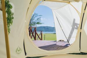 a white tent with a view of the water at Yagaji Beach(屋我地ビーチ) in Nago