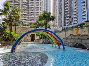 a water slide in a pool in a city at Gin Residence in Jakarta