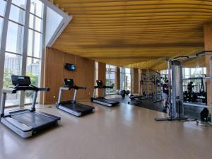 a gym with a bunch of exercise equipment in a building at Gin Residence in Jakarta