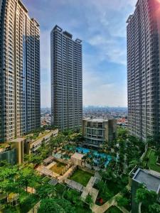 an aerial view of two tall buildings in a city at Gin Residence in Jakarta