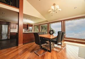 a kitchen and dining room with a table and chairs at Exclusive Private Island - Pacific Ocean Paradise in Madeira Park
