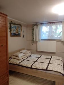 1 dormitorio con 2 camas y ventana en Wegorzewianka 11, en Węgorzewo
