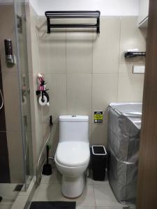 a bathroom with a toilet and a sink at Smdc Breeze Residence in Manila