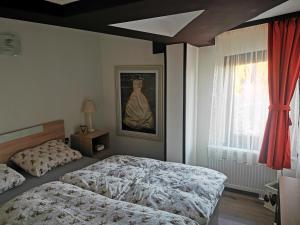 a bedroom with two beds and a painting on the wall at Private Apartments in Hotel Snezhanka in Pamporovo +51 photos