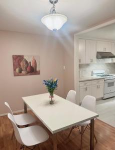 a kitchen with a white table and white chairs at New remol modern tranquil house near SFO in San Mateo