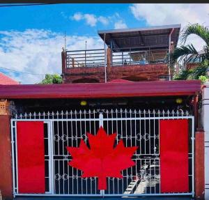 a red maple leaf on the front of a building at affordable 2 bedroom rest house w/ pools & parking in Santa Rosa