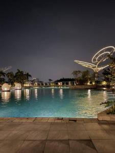 a large pool of water at night with singapore at West Vista Studio Apartment with Netflix in Jakarta