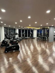 a gym with a bunch of treadmills in a room at West Vista Studio Apartment with Netflix in Jakarta